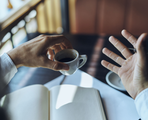 businesswoman in a cafe with a book on the table documents a cup of coffee work lifestyle